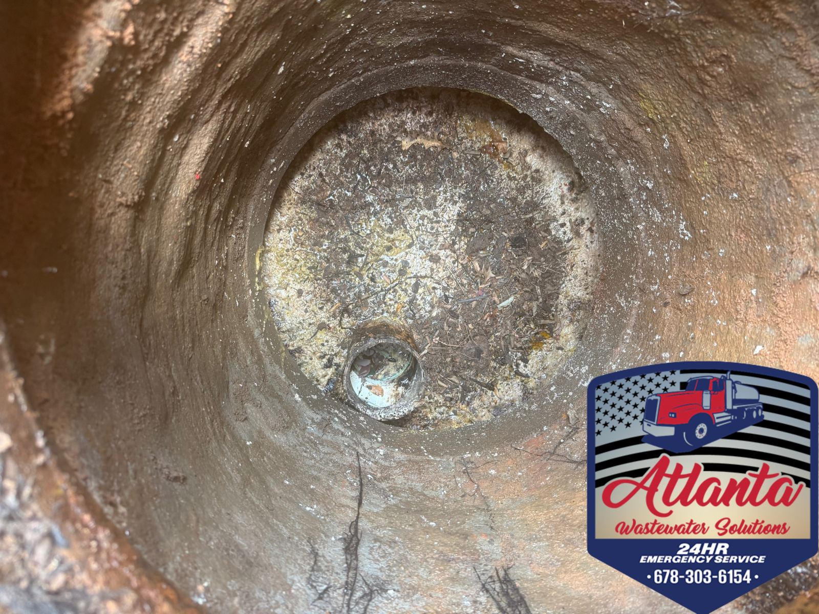 Septic tank lid with Atlanta Wastewater Solutions service sticker