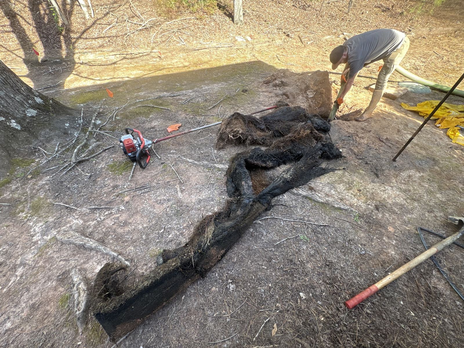Technician working a hose line during an on-site septic service call — Grease Trap Pumping in Lilburn, GA