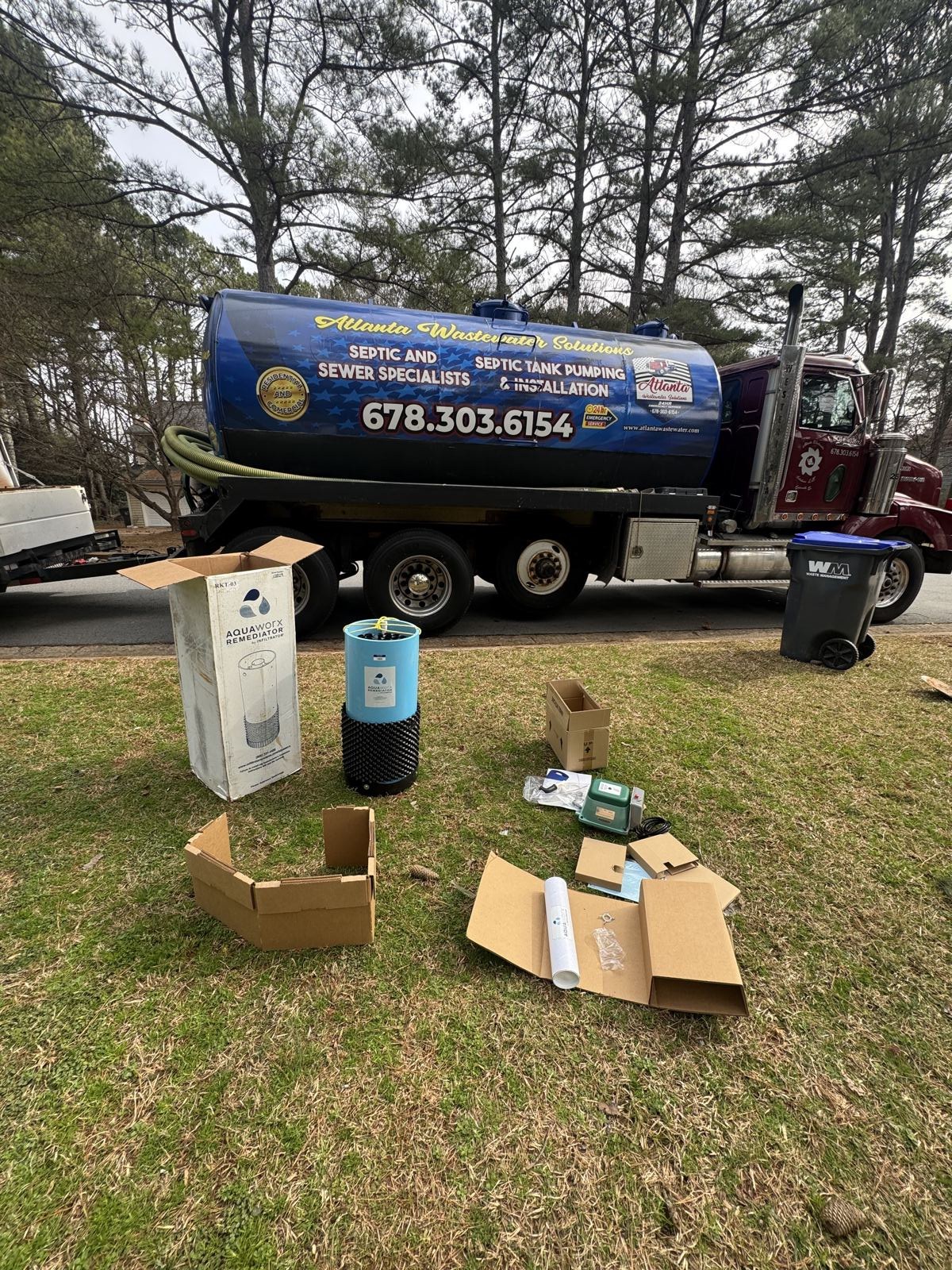 Septic service truck staged on-site with parts and supplies