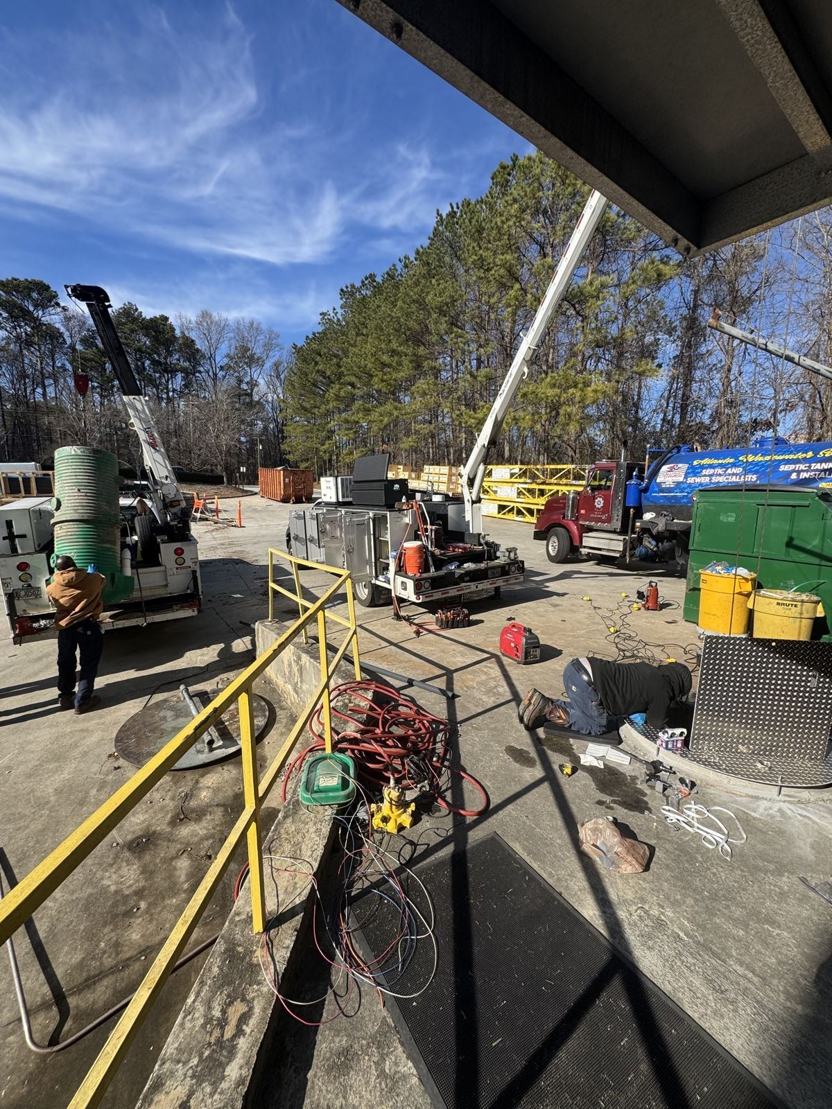 Crew working a commercial sewer line installation with traffic control cones — Eljen Septic Systems in Braselton, GA