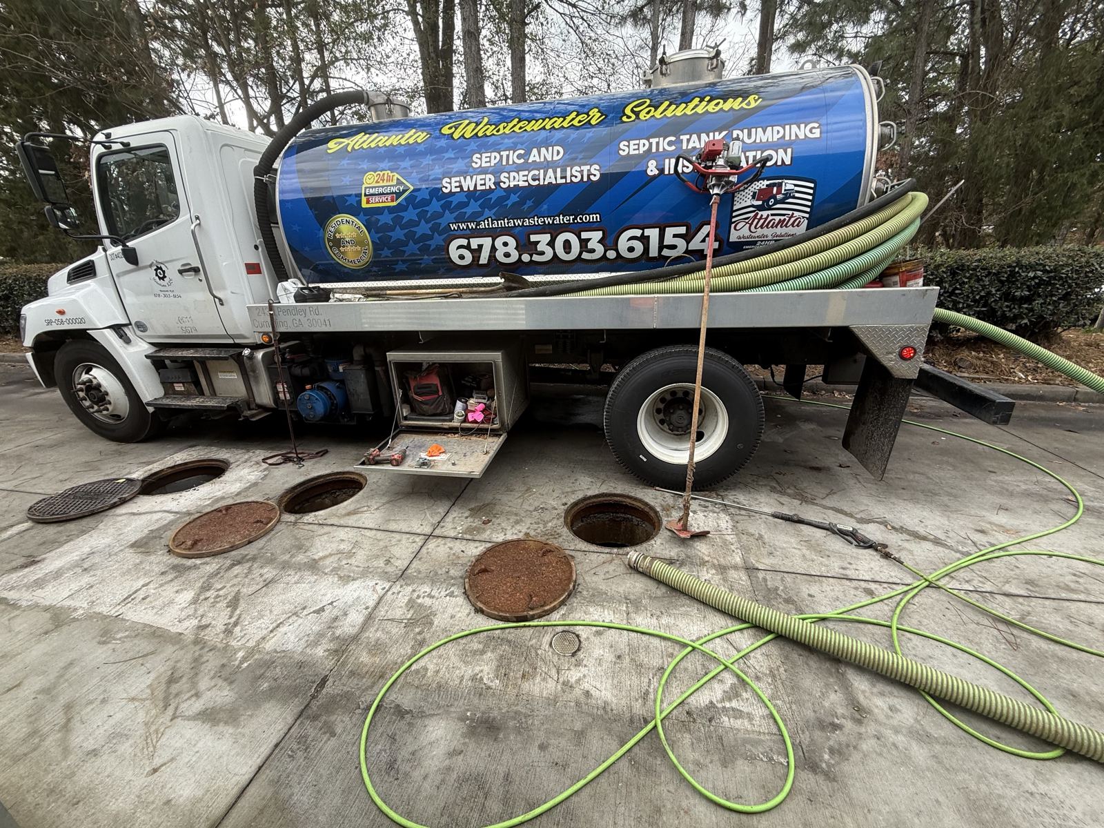 Service truck staged on a residential street during a septic call — Lift Station Repair in Dawson County, GA