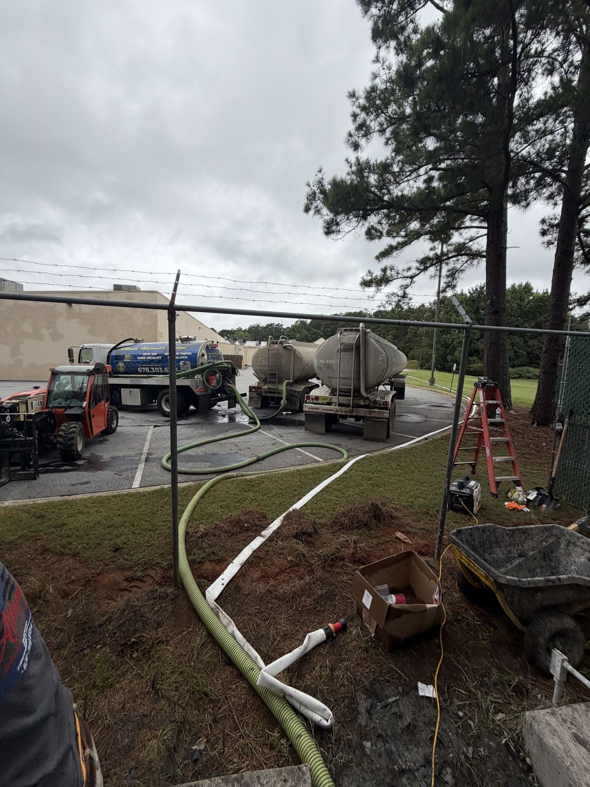 Aerial view of a drainfield trench with pipe runs near a home