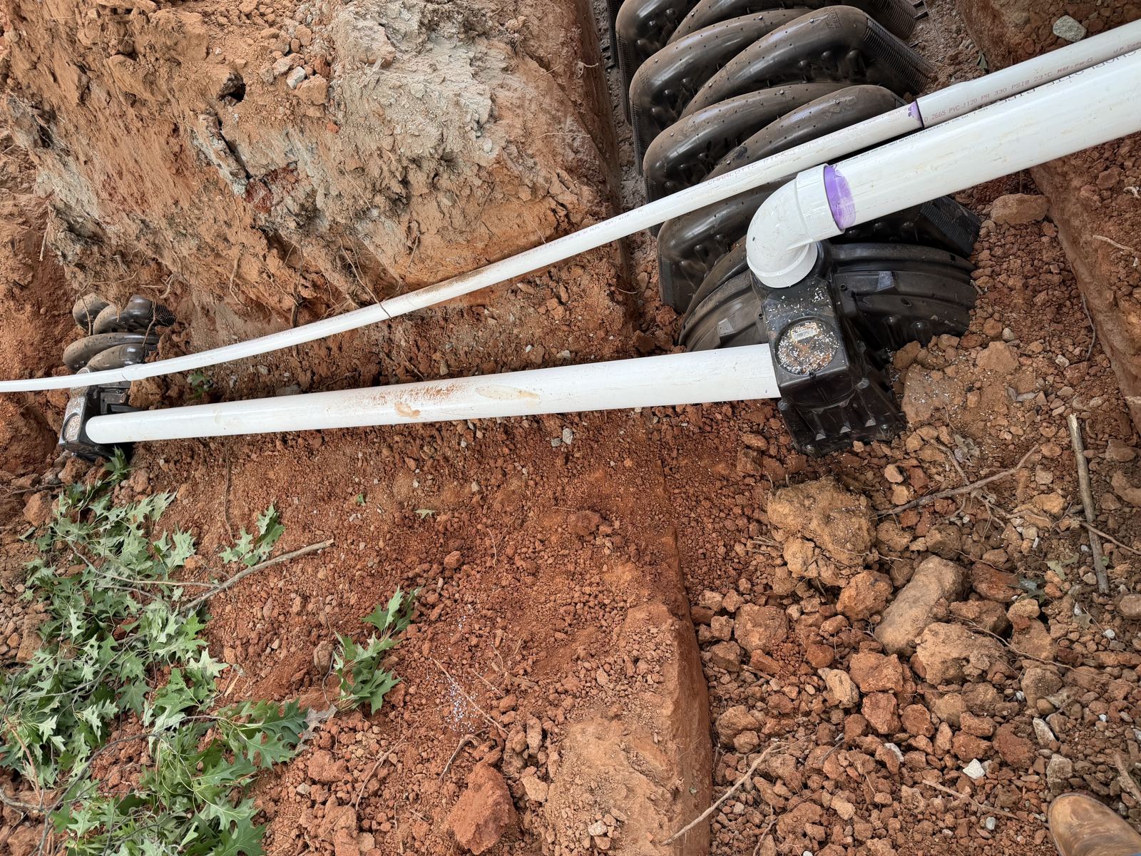 Aerial view of tank access with pipe fittings during service — Grease Trap Pumping in Alpharetta, GA