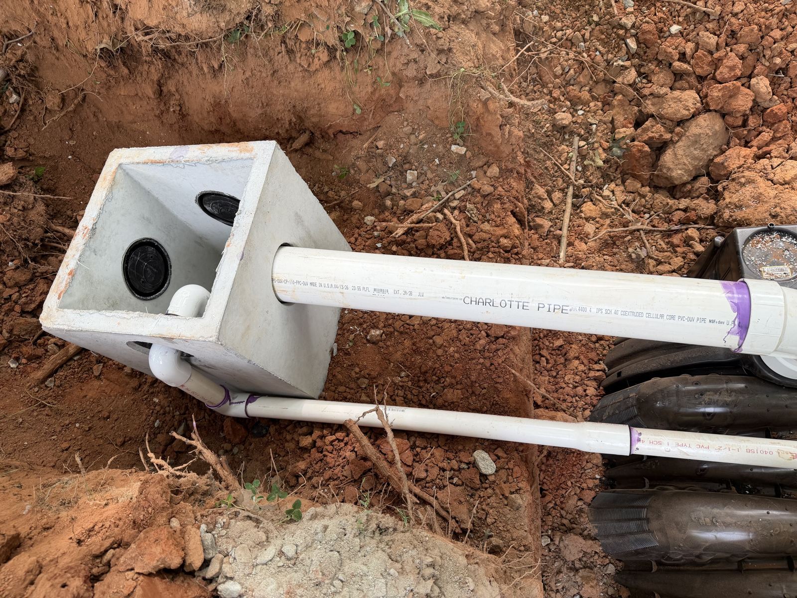 Technician rinsing down a yard after completing a septic service — Eljen Septic Systems in Flowery Branch, GA