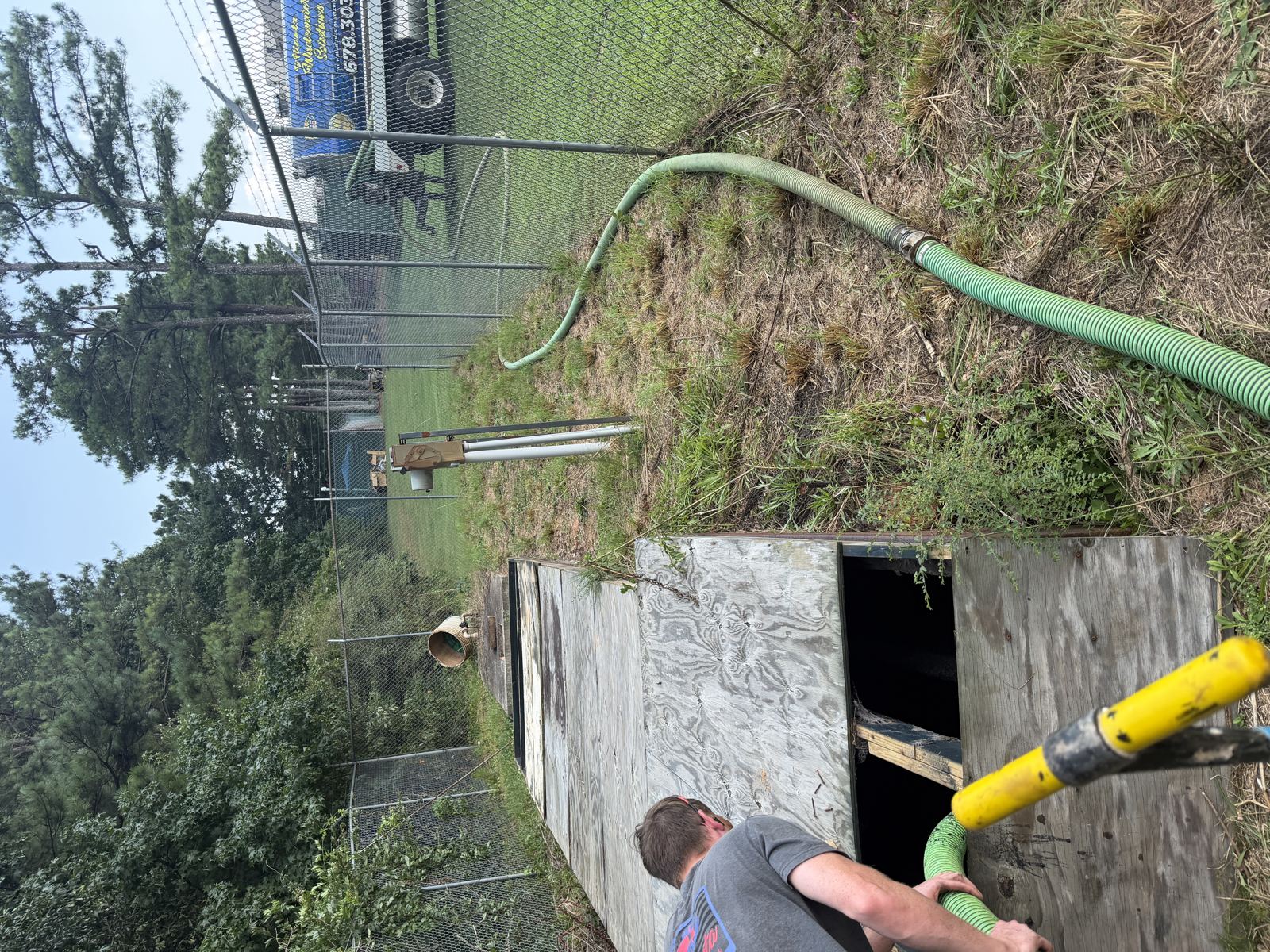 Pipe fitting installed in a wooded drainfield trench — Septic Tank Cleaning in Lilburn, GA