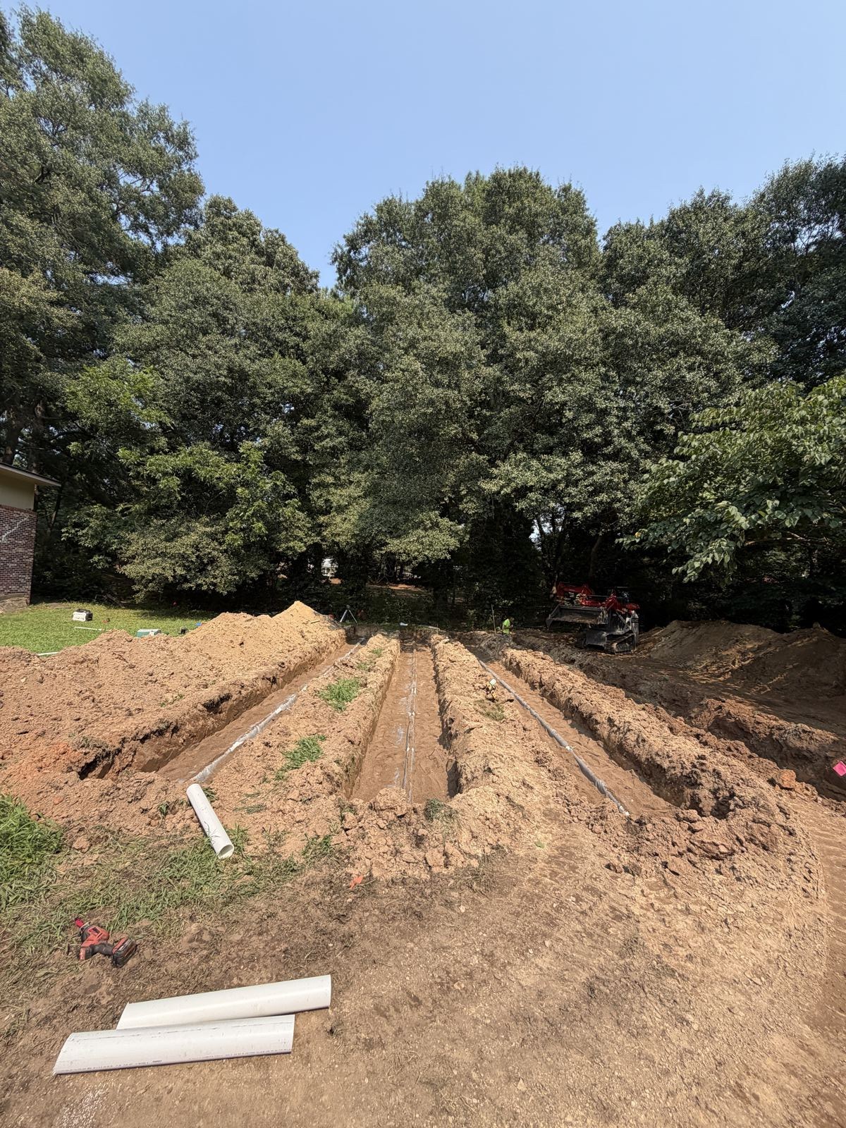 Commercial sewer line service with scaffolding at a building