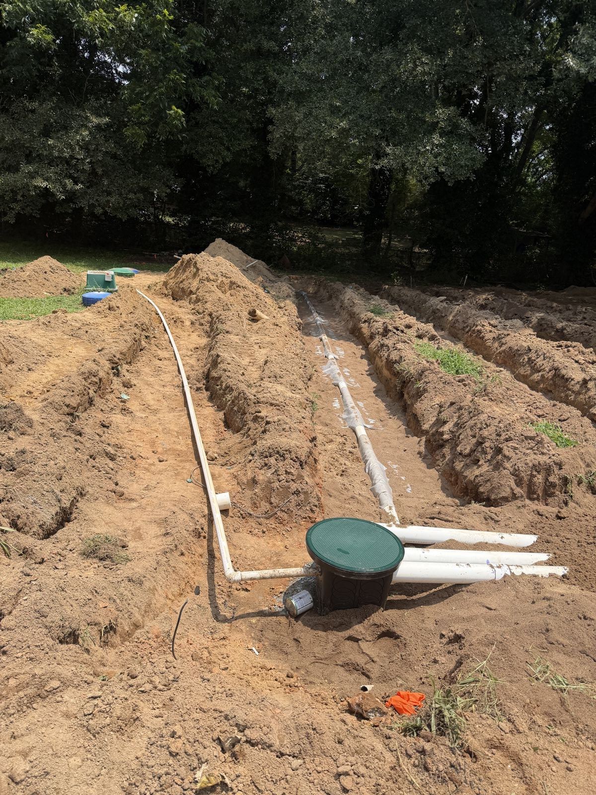 Aerial view of a completed septic installation with capped risers