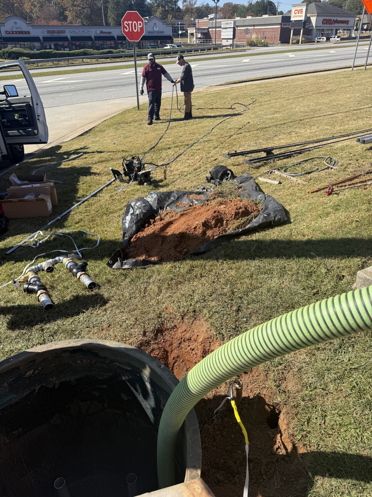 Septic pump hose connected to a residential tank during service — Grease Trap Pumping in Gainesville, GA