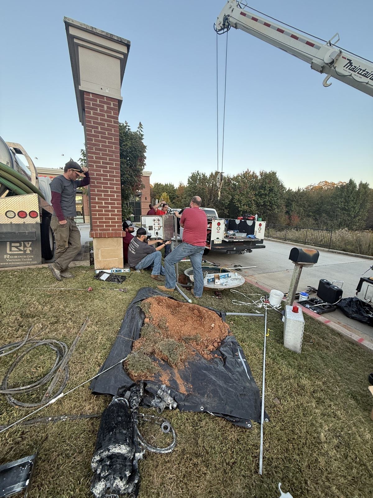 Equipment and service truck staged at a septic job site — Septic Tank Cleaning in Fulton County, GA