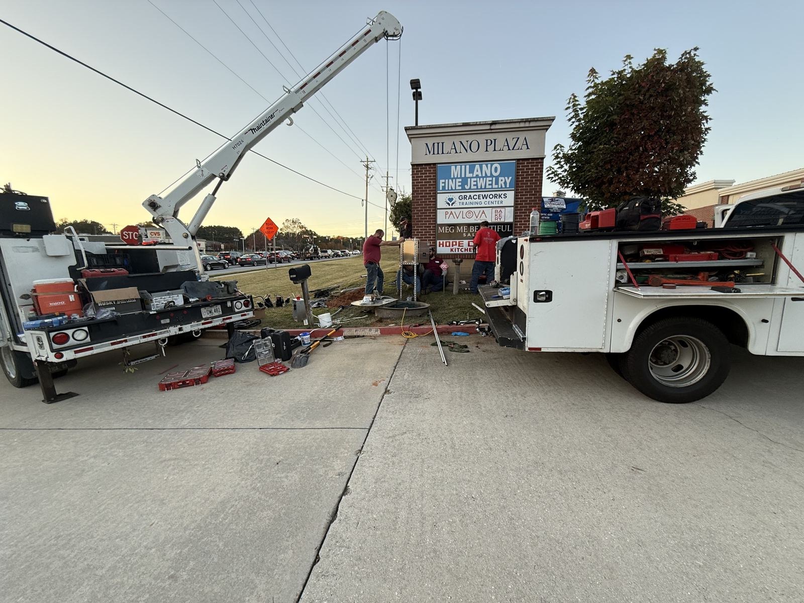 Septic pump truck staged beneath a commercial building overhang — Septic Tank Cleaning in Buford, GA