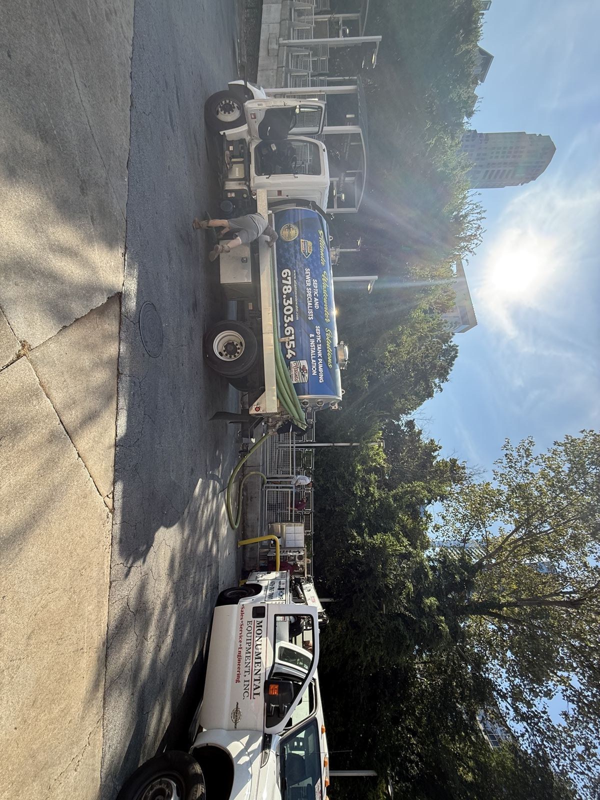 Septic pump truck staged near a commercial loading dock — Septic Tank Cleaning in Lilburn, GA