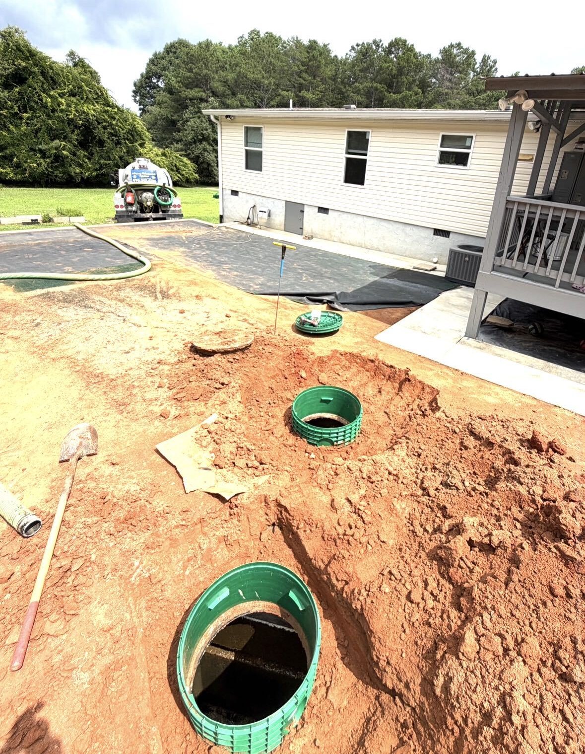 Residential septic tank risers uncovered for inspection at a home in Metro Atlanta